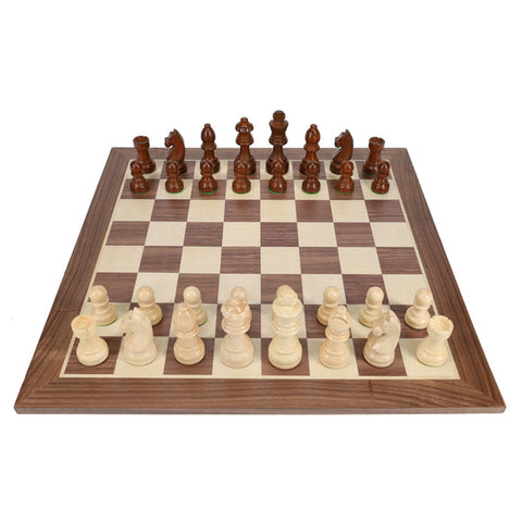 French Staunton weighted chess set with dark walnut board and carved wooden pieces in starting position