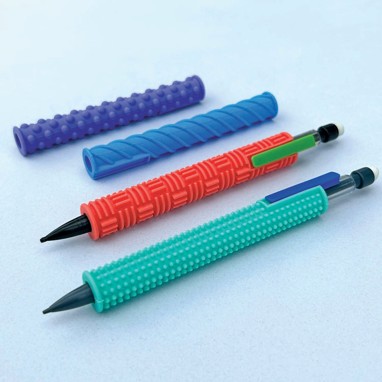 Four textured silicone pencil grip sleeves in teal, red, blue, and purple with two mechanical pencils.