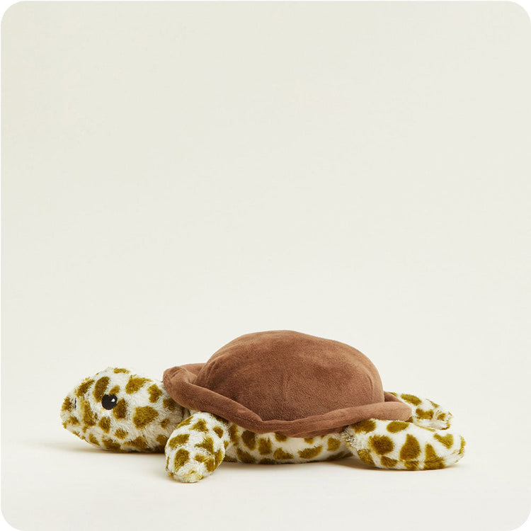 Warmies plush turtle stuffed animal with brown shell and green spotted pattern lying flat
