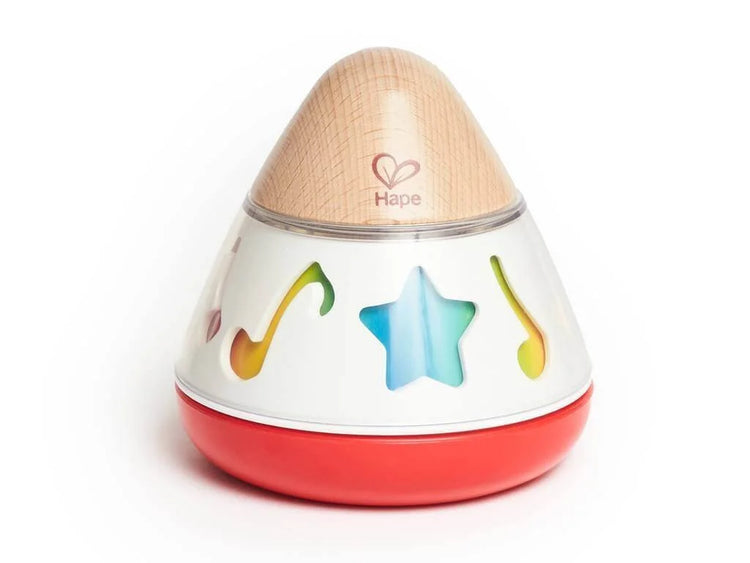 Hape rotating music box with wooden top, white body featuring star and music note cutouts, red base