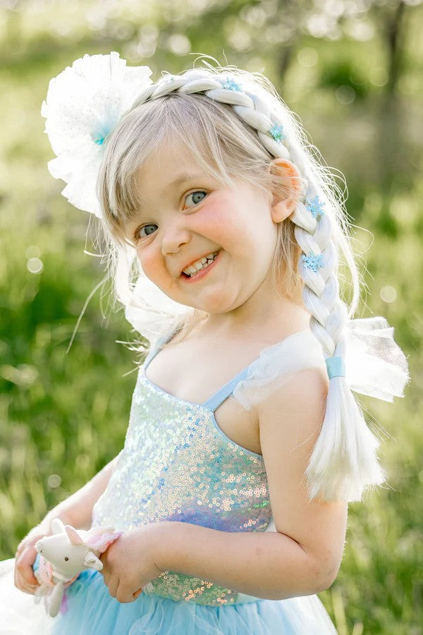Young girl wearing Ice Queen Princess braided hair extension with white flower and blue accents