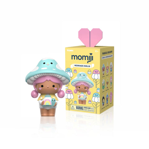 Momiji Magical Meadow blind box message doll with mushroom hat and pink hair beside yellow packaging box