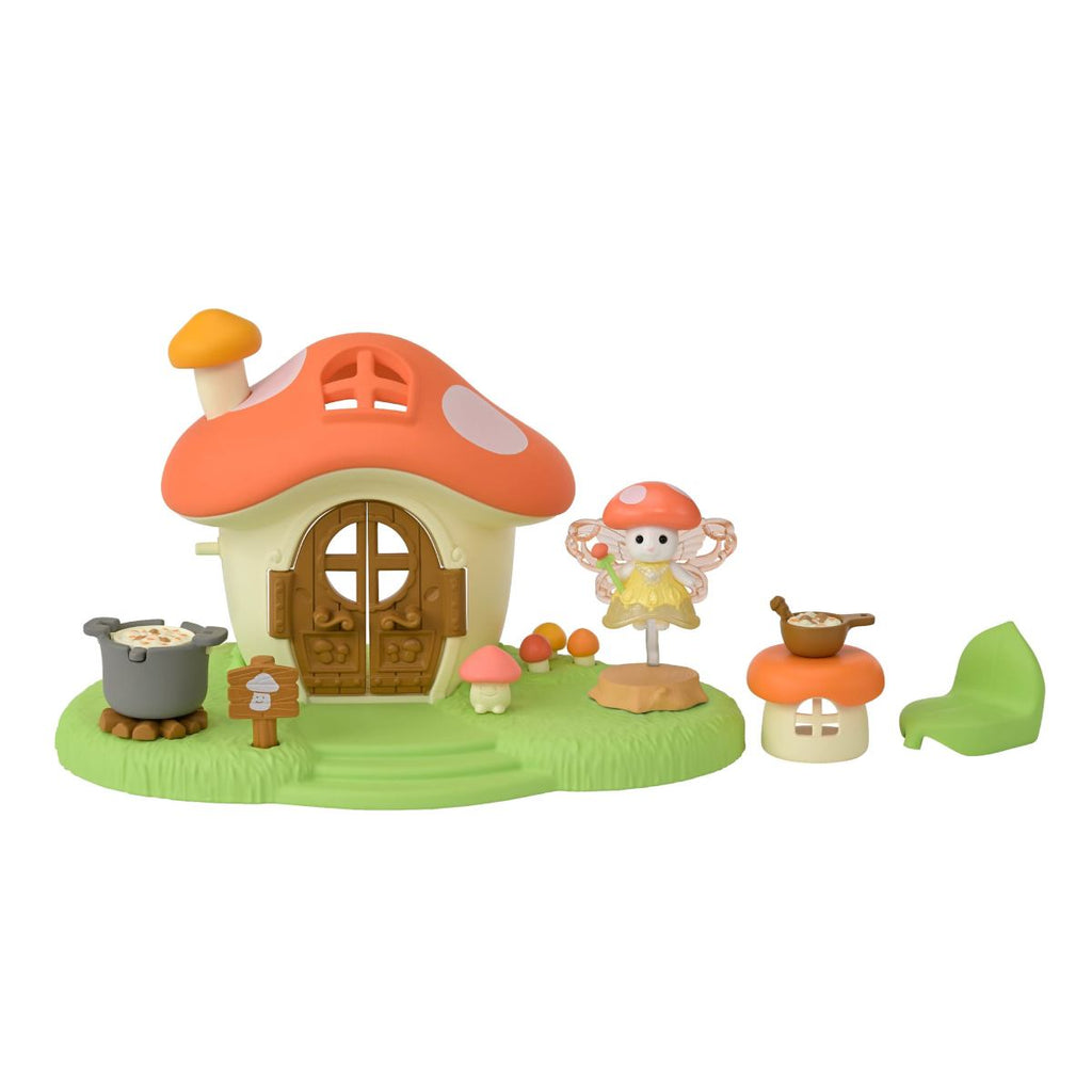 Calico Critters Fairy Mushroom House playset with fairy figure, accessories, and small mushroom furniture on green base.