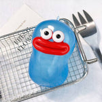 Blue goofy face squishy stress ball with googly eyes and red lips on metal rack