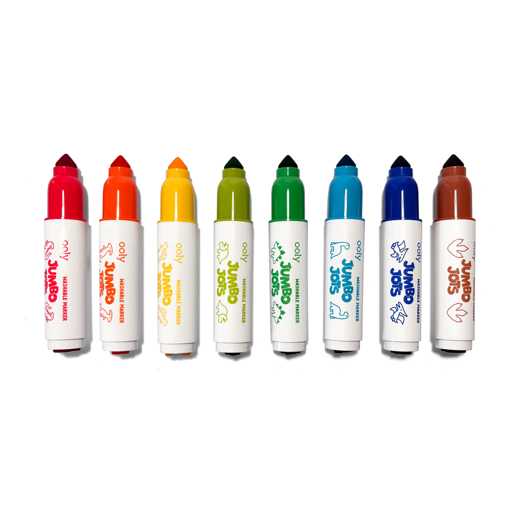 Eight OOLY Jumbo Jots washable dinosaur markers arranged in rainbow color order on white background