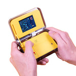Hands holding open PAC-MAN Arcade In A Tin portable handheld game displaying PAC-MAN gameplay screen