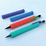 Four textured silicone pencil grip sleeves in teal, red, blue, and purple with two mechanical pencils.