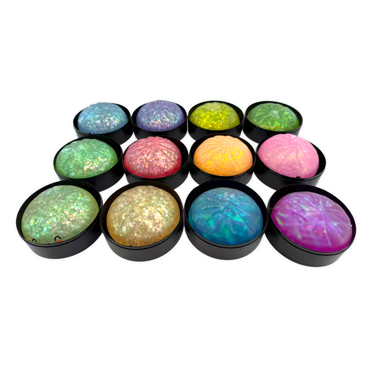 Twelve glittery glow-in-the-dark squishy dumpling toys in colorful holographic assortment in black baskets