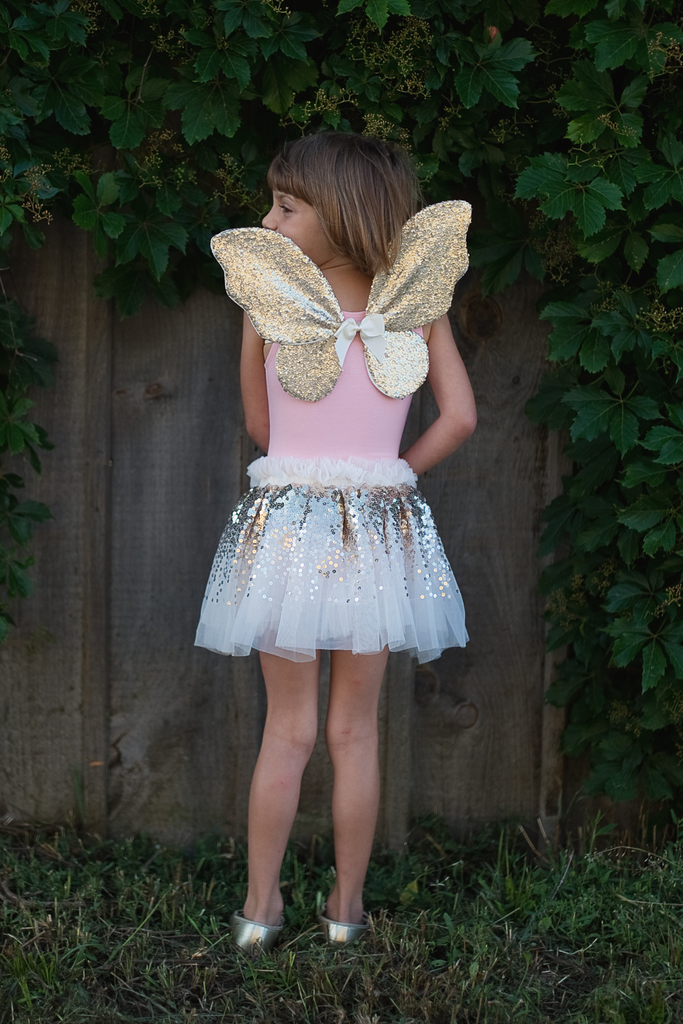 Child wearing gold sequin butterfly wings with silver sequin tutu skirt fairy costume