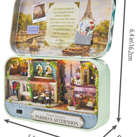 Open tin box displaying DIY Parisian Afternoon miniature scene with tiny Eiffel Tower and cafes