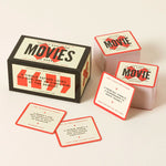 Poorly Explained Movies card game box with sample cards showing humorous movie descriptions on neutral background