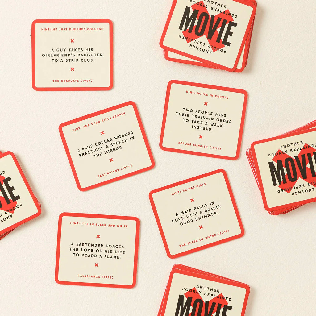 Poorly Explained Movies card game cards scattered showing humorous movie descriptions on cream and red cards