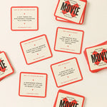 Poorly Explained Movies card game cards scattered showing humorous movie descriptions on cream and red cards
