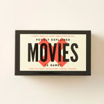 Poorly Explained Movies card game box with black border and red diamond graphic on cream background.