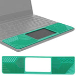 Green silicone sensory mat with textured patterns fitting over a Chromebook trackpad area