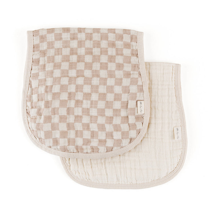 Two muslin burp cloths in taupe checkered and solid cream patterns with curved edges
