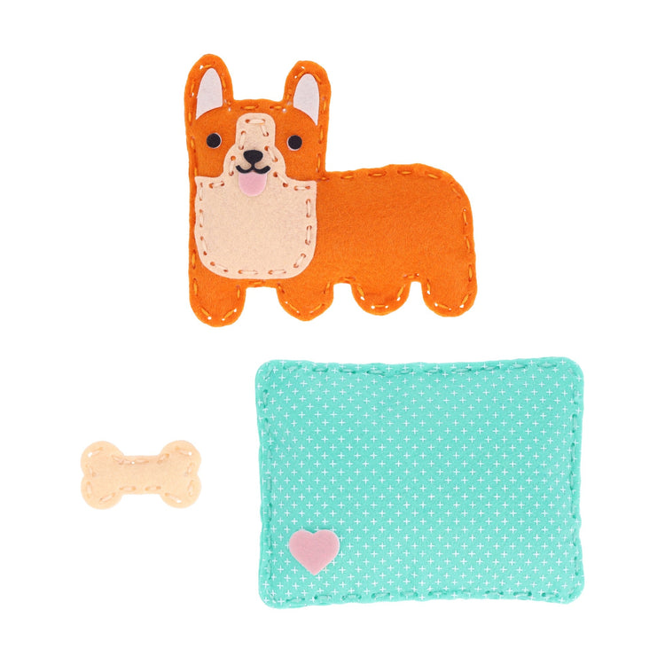 Felt corgi craft kit with orange dog, teal patterned bed, and bone accessory on white background