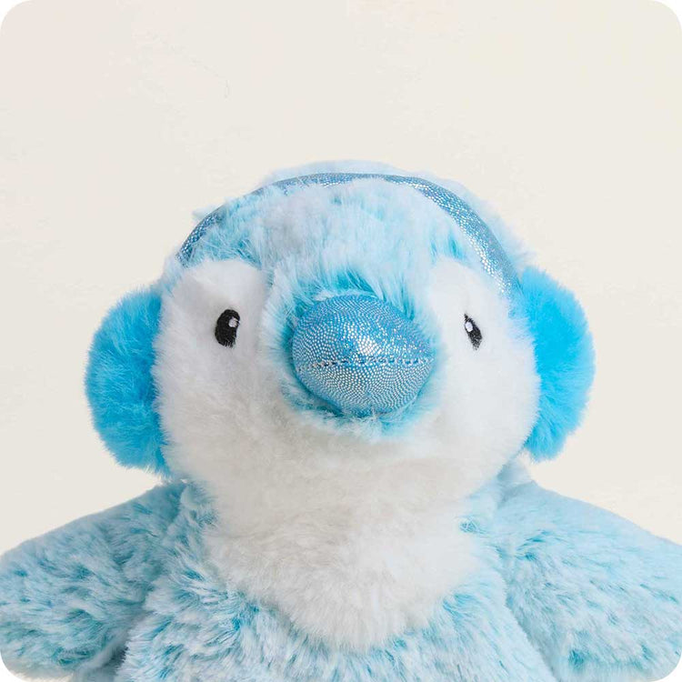 Blue plush penguin stuffed animal with sparkly blue nose and ear muffs on white background