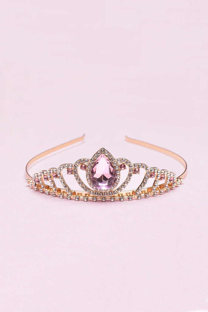 Rose gold tiara headband with pink teardrop gemstone and rhinestone embellishments on pink background
