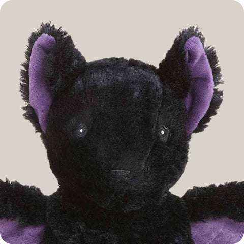 Warmies black plush bat stuffed animal with spread purple wings and ear lining