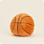 Warmies plush basketball stuffed animal with black seam lines on neutral background