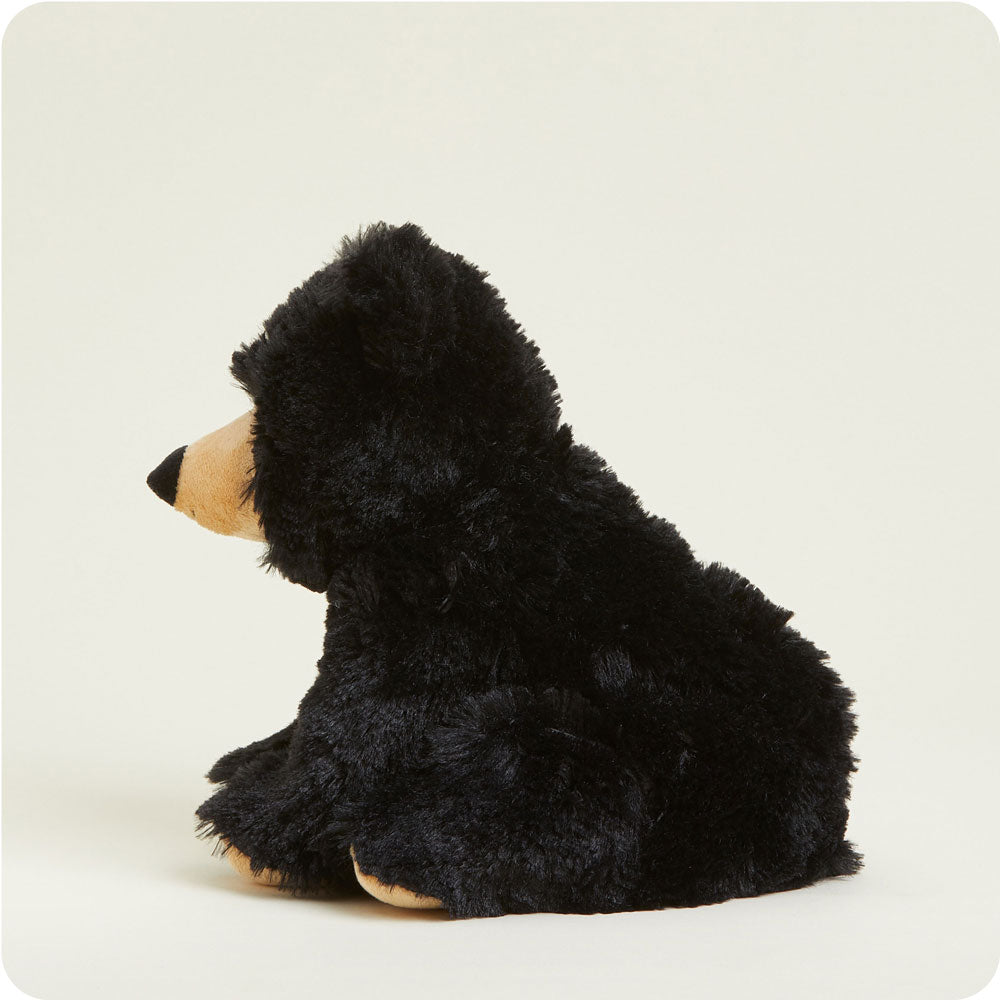 Black bear Warmies Junior plush stuffed animal shown from rear three-quarter view seated position