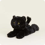 Black plush stuffed cat toy with yellow eyes lying down on white background