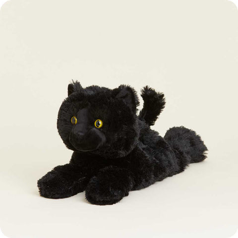 Black plush stuffed cat toy with yellow eyes lying down on white background