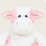 Warmies Strawberry Cow stuffed animal with white plush body and pink accents