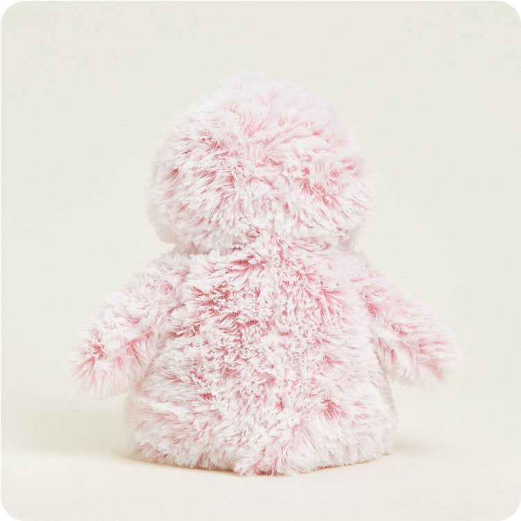 Pink fluffy Warmies penguin stuffed animal shown from the back on neutral background