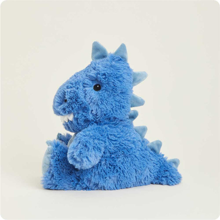 Blue fluffy T-Rex Warmies stuffed animal with spikes and white teeth sitting upright