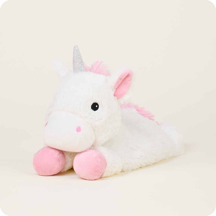 White plush unicorn stuffed animal lying down with pink ears, mane, and hooves