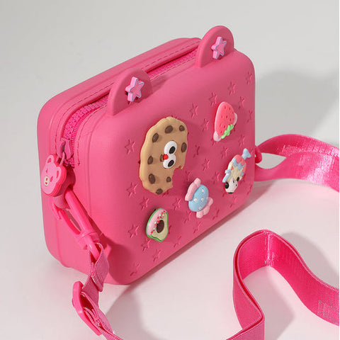 Hot pink silicone crossbody bag with cute food charm decorations and adjustable strap