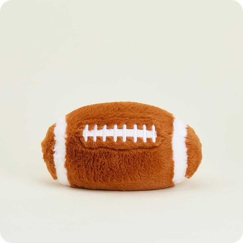 Warmies plush football stuffed animal with white laces on cream background