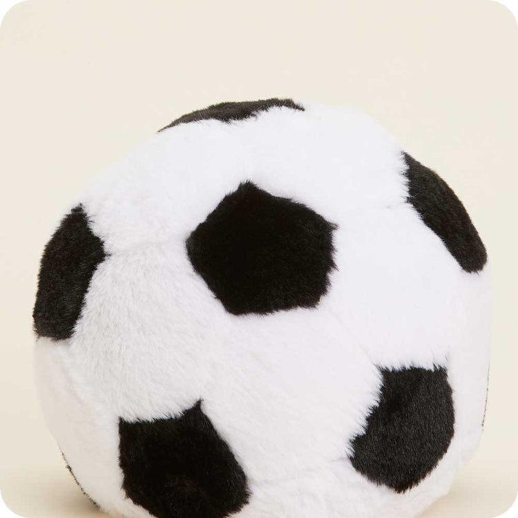 Warmies plush soccer ball stuffed animal with black and white pattern on cream background