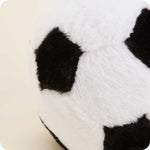 Close-up of a plush soccer ball stuffed animal with black and white fuzzy fabric panels