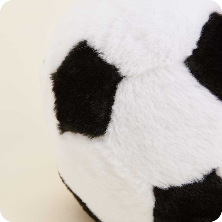Close-up of a plush soccer ball stuffed animal with black and white fuzzy fabric panels