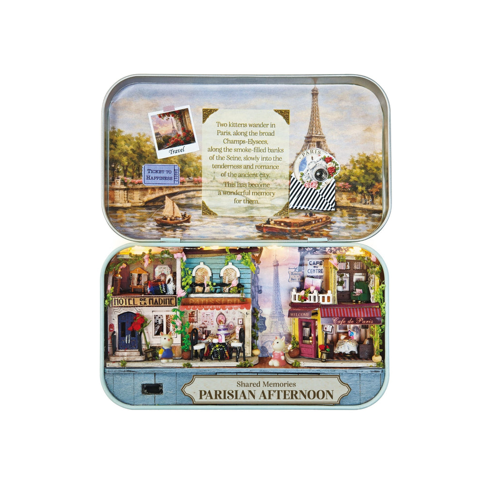Open tin box displaying DIY Parisian Afternoon miniature scene with tiny Eiffel Tower and cafes