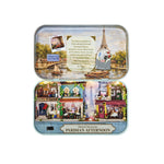 Open tin box displaying DIY Parisian Afternoon miniature scene with tiny Eiffel Tower and cafes