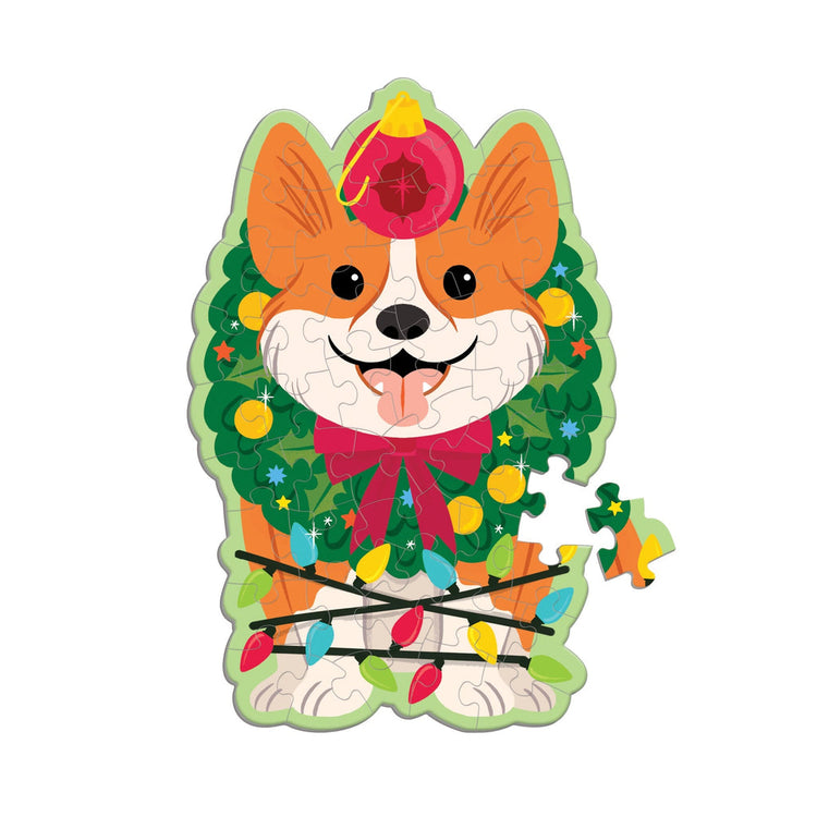 48-piece shaped scratch and sniff puzzle featuring a smiling Christmas corgi with holiday wreath and lights