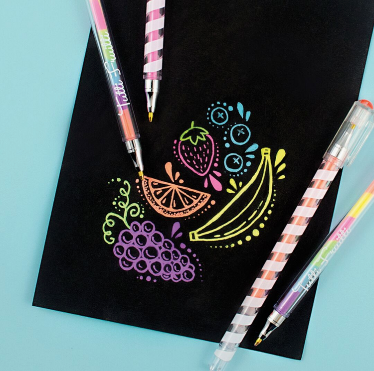 Tutti Fruitti scented multicolor gel pens with striped barrels beside colorful fruit artwork on black paper