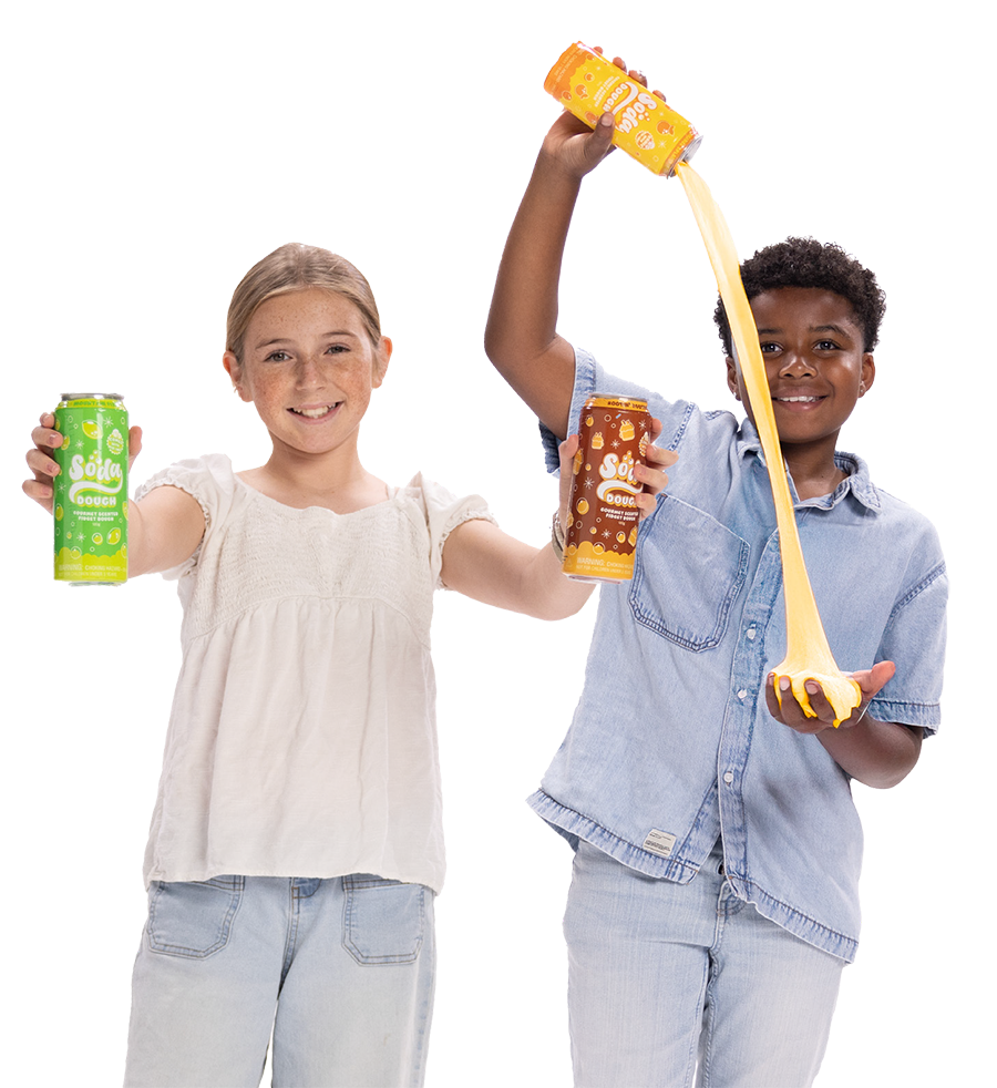 Two children holding Soda Dough cans while yellow slime pours from an orange can