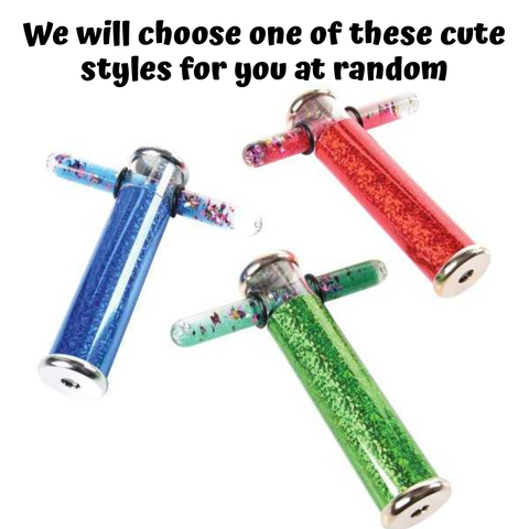 Young girl holding and looking through a green glitter wand kaleidoscope toy