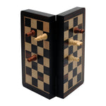 Magnetic folding wooden chess set in black stain with chess pieces attached to board