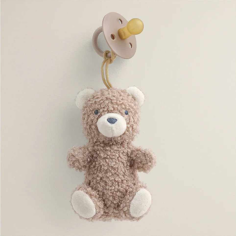 Bitzy Pal plush bear toy attached to a natural rubber pacifier on neutral background