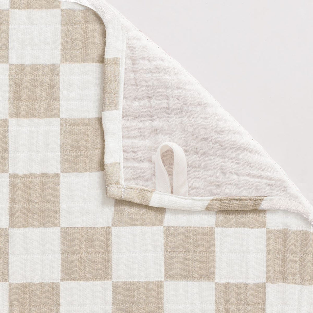 Taupe and white checkerboard muslin nursing cover with hanging loop detail showing reverse side
