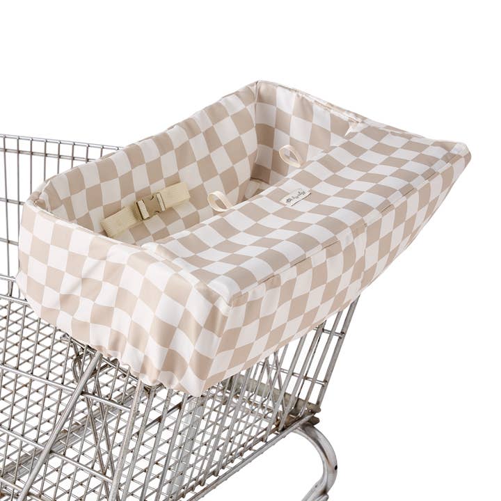 Beige and white checkerboard shopping cart cover with safety buckle installed on metal cart