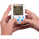 Two hands holding a miniature white Tetris keyring arcade handheld game with blue buttons