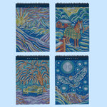 Four spiral-bound FlowArt dot-by-letter notebooks featuring winter-themed metallic mosaic artwork on dark blue covers