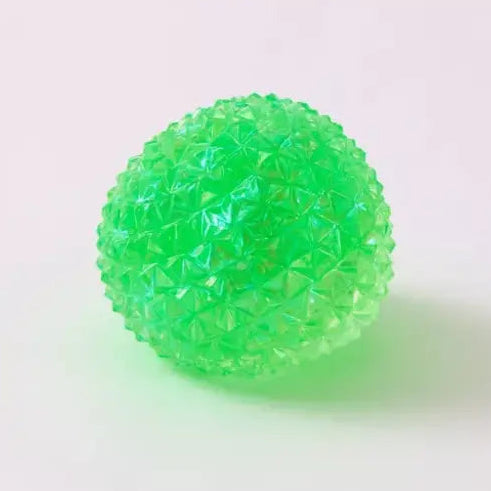 Bright green spiky squishy orb toy with textured bumpy surface on white background